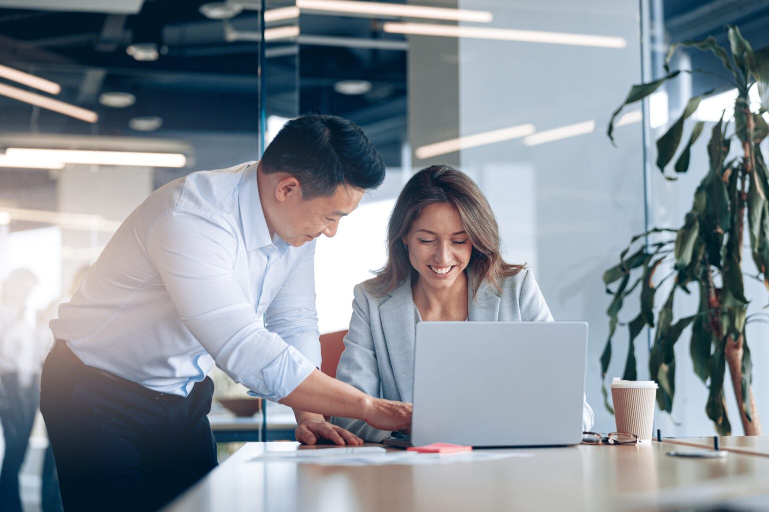 Two colleagues collaborating at a laptop