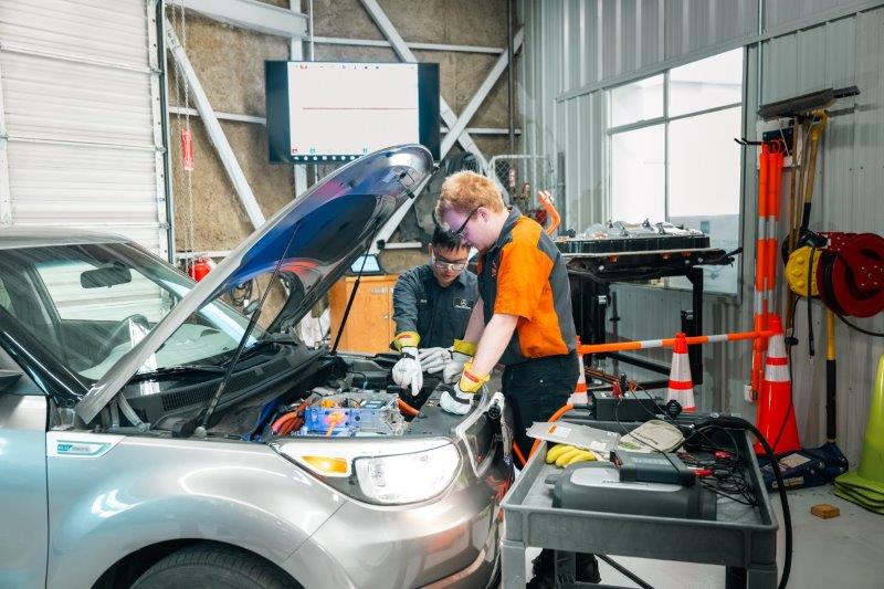 Students working on electric vehicle engine