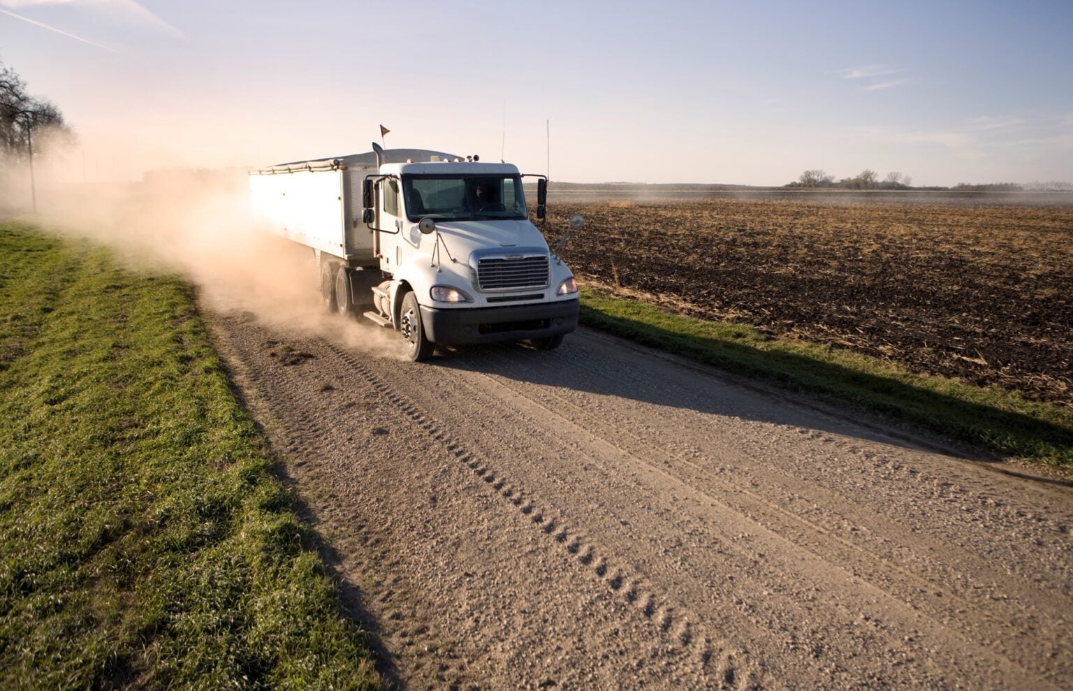 Truck driving on rural dirt road