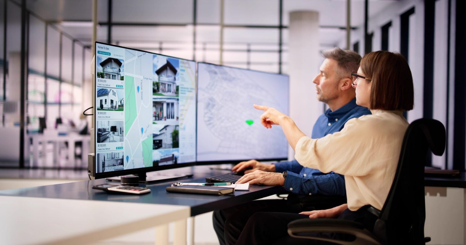 Two people analyzing architectural designs