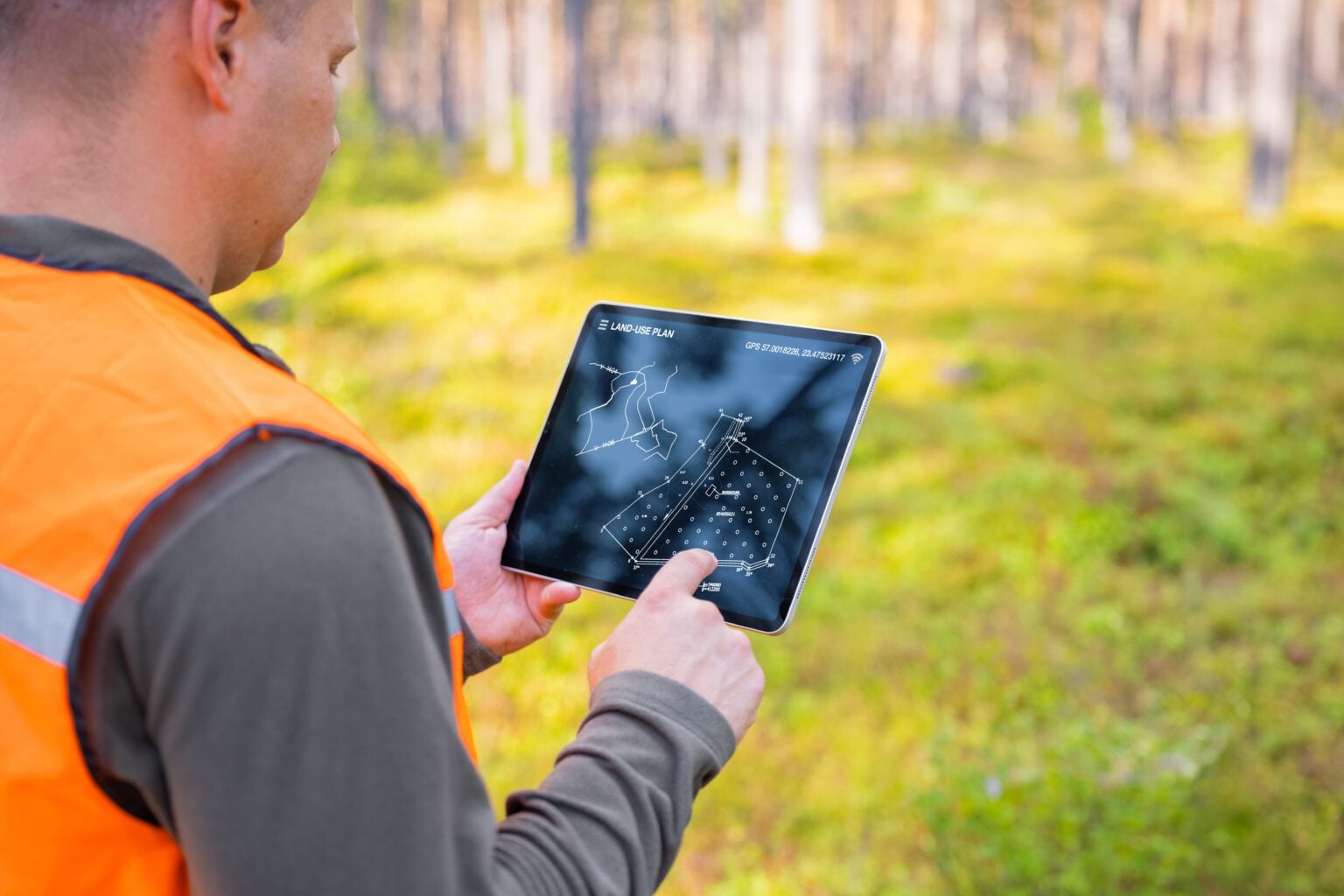 Person using tablet in forest