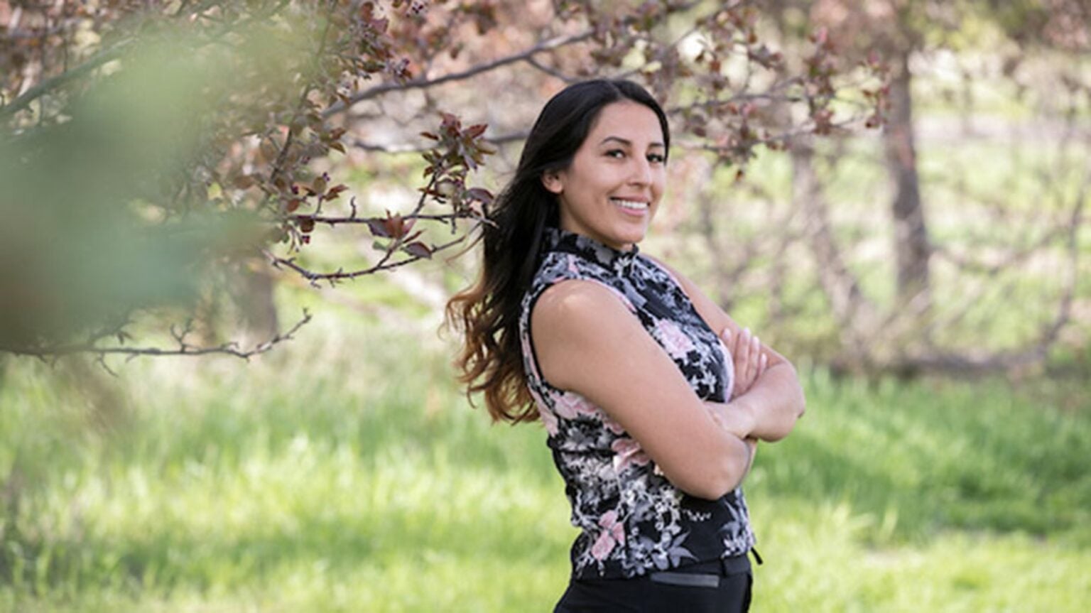 Smiling woman standing outdoors, confident.