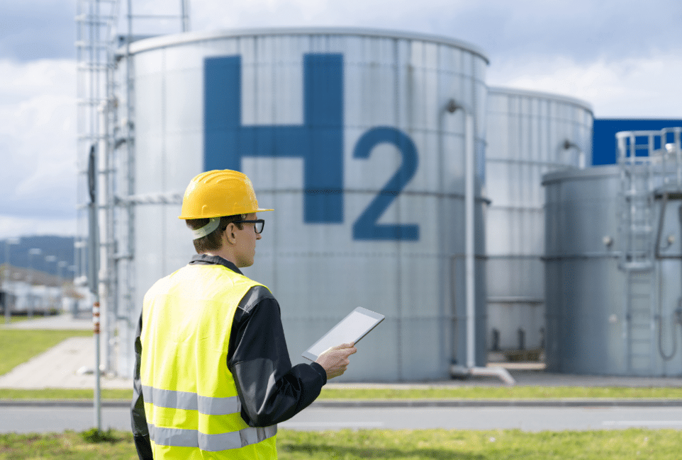 Worker inspecting hydrogen storage tanks.