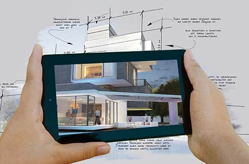 Hands holding tablet displaying architectural design
