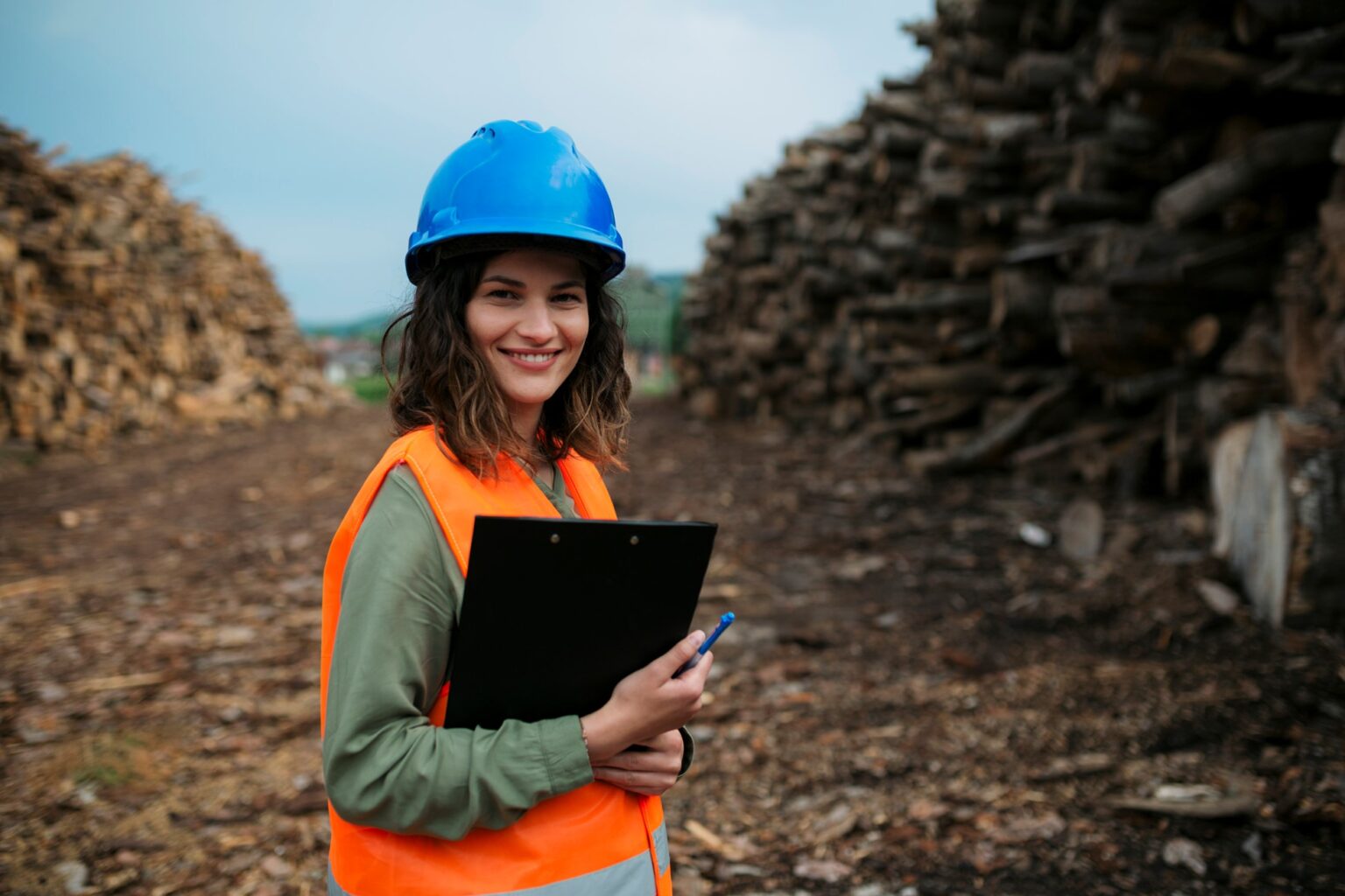 Smiling woman in safety gear outdoors